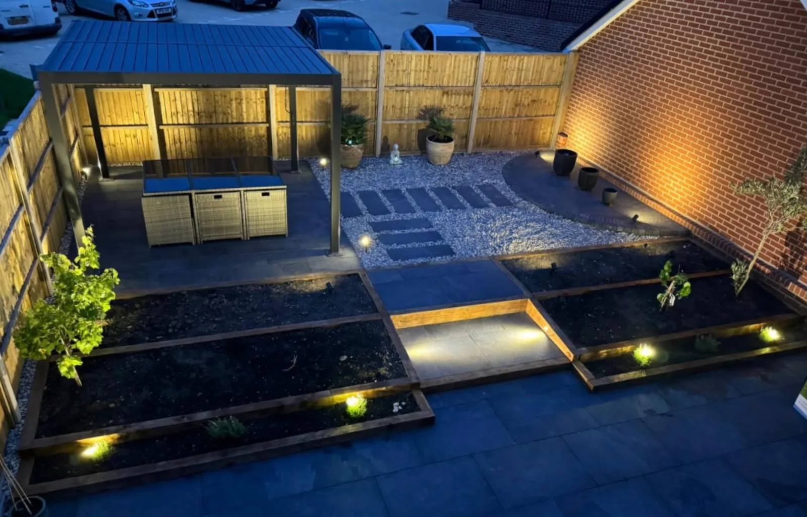 Porcelain patio, pergola and raised planters installed by HLS in Hampshire