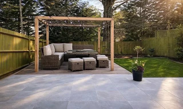 Supplied project photograph showing a timber pergola, paved terrace and lawn