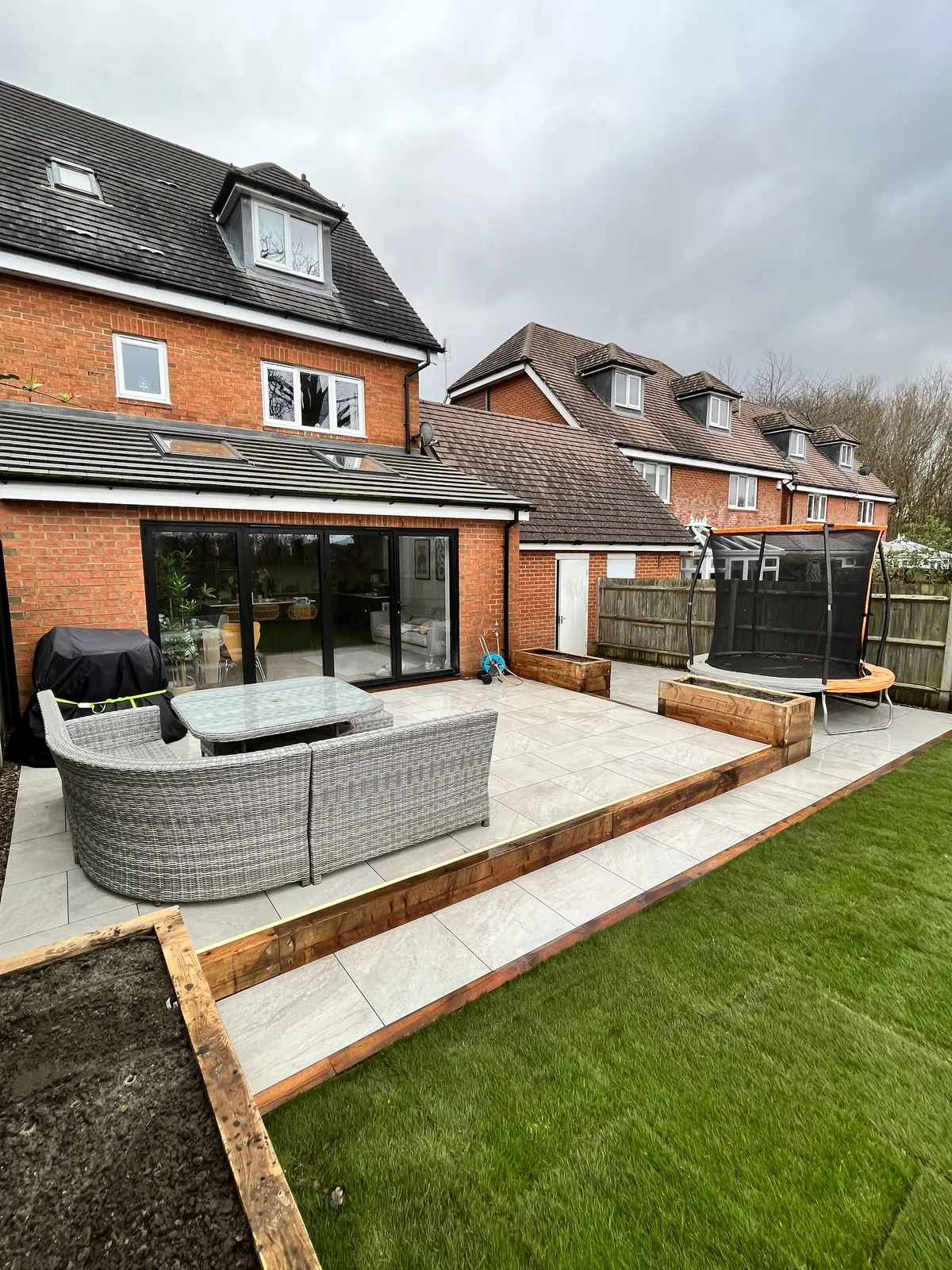 Tiered porcelain paving, raised planters and turf installed by HLS in Horsham